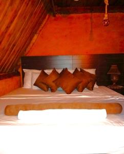 a bed with a bunch of pillows on it at Shia in Ella