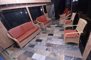 a group of chairs and a couch on a tile floor at Residencial Morumbi Hostel in Sao Paulo