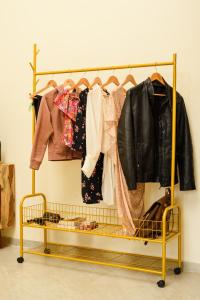 a clothes rack with clothes on it at La Luxo Anjuna in Bardez
