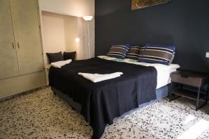 a bedroom with a large bed with blue pillows at Mark House in Nazareth