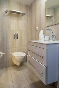 a bathroom with a toilet and a sink at Mark House in Nazareth +36 photos