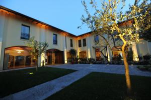 a large house with a tree in front of it at The Ziba Hotel & Spa in Peschiera del Garda