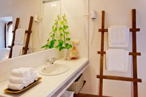 a bathroom with a sink and a mirror at Hotel Can Roses in Sóller