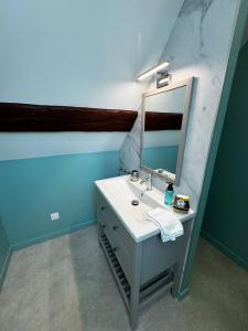 a bathroom with a white sink and a mirror at Au pré des pierres in Sancé +55 photos