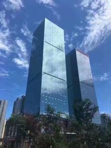a tall building with a lot of windows on it at Qingdao Jianxin International Hotel in Qingdao
