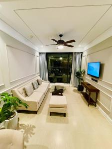 a living room with a couch and a flat screen tv at Luxury Apartment with Ocean View - 1 minute to beach in Da Nang