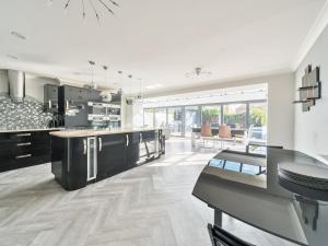 a kitchen with a large island in the middle at Pass the Keys Large Family Home Parking - Oxford in Oxford