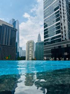 a pool of water in front of a city at KLcc suites tower 2 in Kuala Lumpur