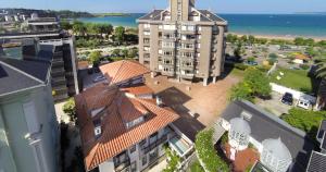 a large building with a clock tower on top of it at Hotel Boutique Las Brisas in Santander