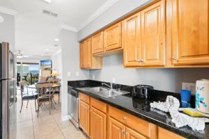 a kitchen with wooden cabinets and a sink at Laguna Bella C4 in Gulf Shores