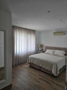 a bedroom with a large bed and a window at Villa rooftop with stunning view apartment in Amman
