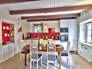 a kitchen with a wooden dining room table and chairs at Holiday Home in Huelgoat near Monts d'Arrée in Huelgoat