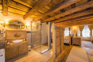 a large bathroom with a sink and a shower at Casa Savri in Sighişoara