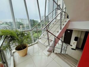 a staircase in a building with a potted plant at Travelbee Business Inn in Cebu City