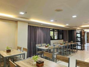a restaurant with tables and chairs in a room at Travelbee Business Inn in Cebu City