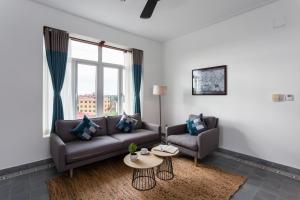 a living room with a couch and a table at Boutique Kampot Hotel in Kampot