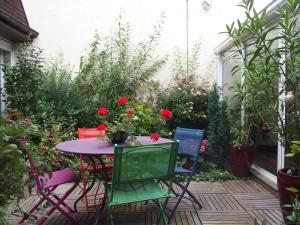 una mesa y sillas en un jardín con flores en Bed and Breakfast Le patio en Montigny-lès-Metz