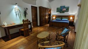 a bedroom with a bed and a desk and chairs at Lagoon gate Tangalle Resort in Tangalle +212 photos