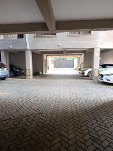 a large parking garage with cars parked in it at Starla one bedroom duplex in Kinoo