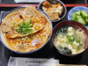 a group of bowls of food with soup and vegetables at 民宿たけだ家 in Saka