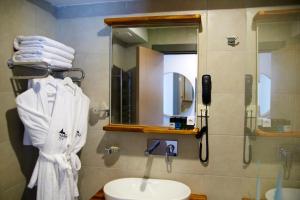 a bathroom with a sink and a mirror and towels at Tophane Suites in Istanbul +50 photos