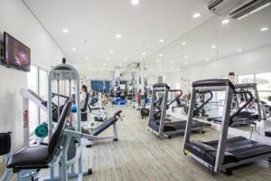 a gym with several tread machines in a room at Natture Condomínio Clube in Natal