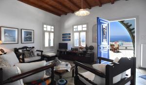 a living room with a view of the ocean at Tinos Sky View Villa in Arnados