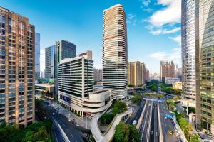 a city with tall buildings and a street with cars at Holiday Inn Guangzhou Zhujiang New Town in Guangzhou