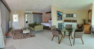 a living room with a glass table and a bedroom at Breakfast at Monaco - Palais Boracay in Boracay