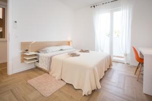 Postel nebo postele na pokoji v ubytování Apartments Tamburini