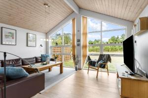 a living room with a couch and a table at TV1686-Jerup-Kuskevej-26 in Bratten Strand