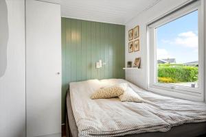 a bedroom with a bed with a window at SJ305-Hejls-Overbakken-5 in Hejlsminde