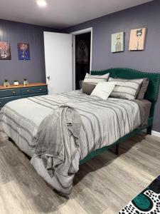 a bedroom with a large bed with a green headboard at Private Oasis in the Mountains in Oroville +43 photos