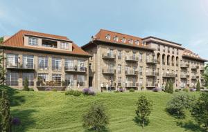 a large building with a green lawn in front of it at Apartment Blankenburg in Bad Frankenhausen