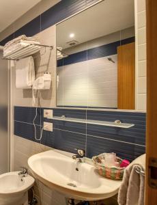 a bathroom with a sink and a mirror at Hotel San Remo in Rome