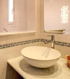 a bathroom with a white bowl sink on a counter at Hotel San Remo in Rome