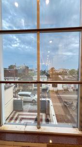 a view of a parking lot from a window at Raghukul by Namamispiritualyatra in Ayodhya