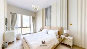 a bedroom with a large bed and a large window at Luxury 2BR Beside Burj Khalifa & Dubai Mall Enjoy Dubai Skyline From Balcony Like Home in Dubai +19 photos