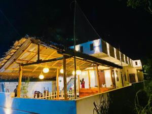 a house on a boat in the water at night at Azure bay in Matara