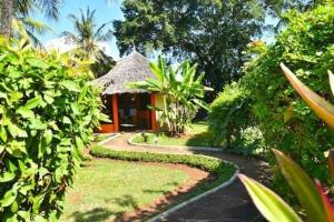 a path leading to a house in a garden at Kasuku villa in Ukunda