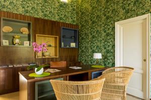 a dining room with a wooden table and chairs at Relais Regina Giovanna in Sorrento