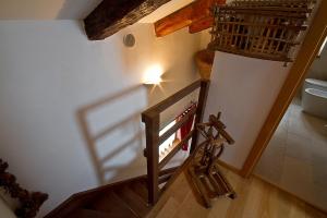 a stairway with a wooden railing and a stair case at Casa Cebajova Poesia in Tribil di Sopra