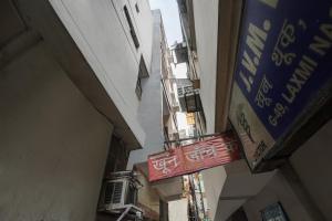 an alley with signs on the side of a building at Hotel Twamev Couple Friendly Laxmi Nagar in New Delhi