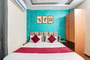 a bedroom with a large bed with red pillows at Hotel Twamev Couple Friendly Laxmi Nagar in New Delhi