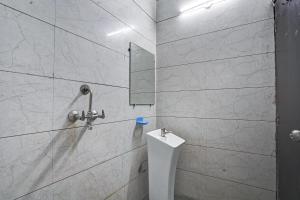 a bathroom with a shower with a toilet and a mirror at Hotel Twamev Couple Friendly Laxmi Nagar in New Delhi +16 photos