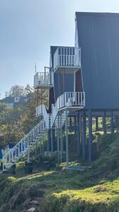 a house with stairs leading up to a building at Reveries Valley Kodaikanal in Kodaikānāl