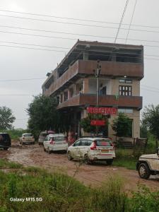 a building with cars parked in front of it at Hotel parshuram in BhÄdura