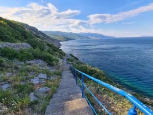 a stairway leading down to a body of water at Charming apartment with private terrace in Senj +21 photos