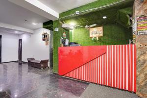 a red door in a room with a green wall at Hotel Twamev Couple Friendly Laxmi Nagar in New Delhi