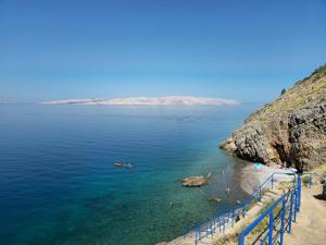 a beach with people swimming in the water at Apartment in Croatia near Adriatic Coast in Senj +20 photos